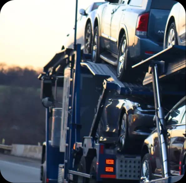 Vehicles secured on an open car carrier