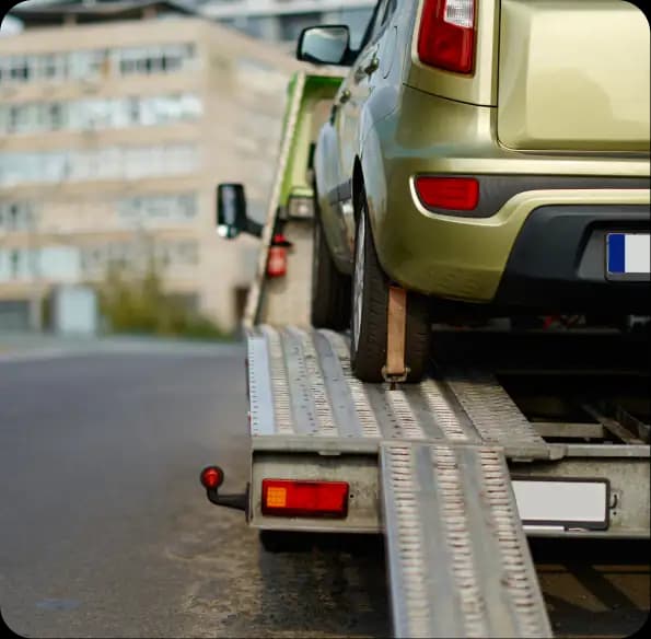 Car loaded on a tow truck ramp