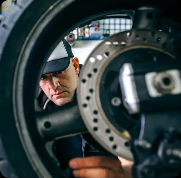 Mechanic inspecting a motorcycle wheel