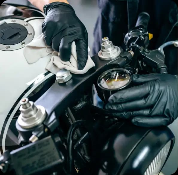 Worker adjusting motorcycle controls