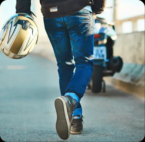 Person carrying a motorcycle helmet