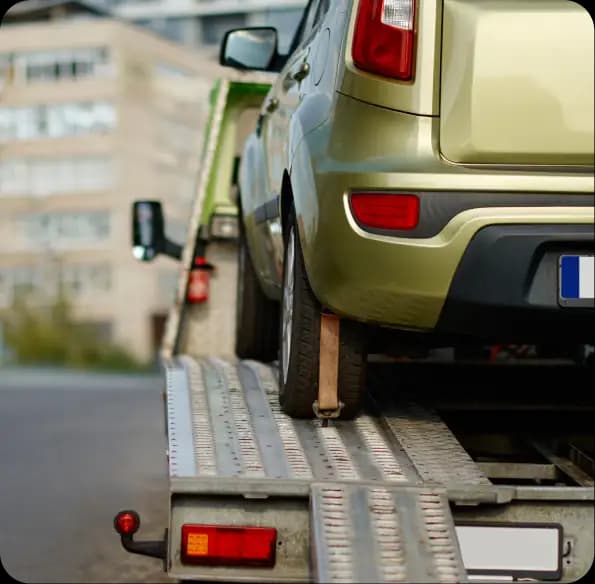 Car loaded on a tow truck ramp