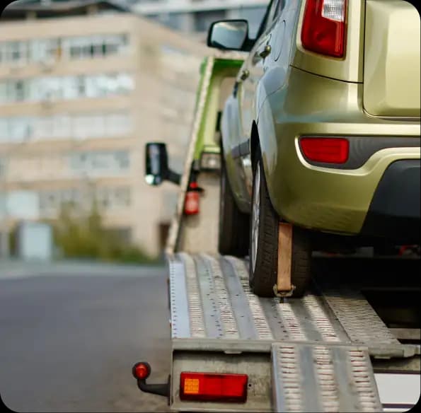Car loaded on a tow truck ramp