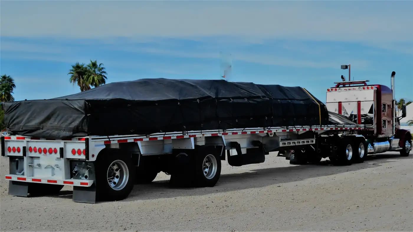 Covered cargo secured on a flatbed truck