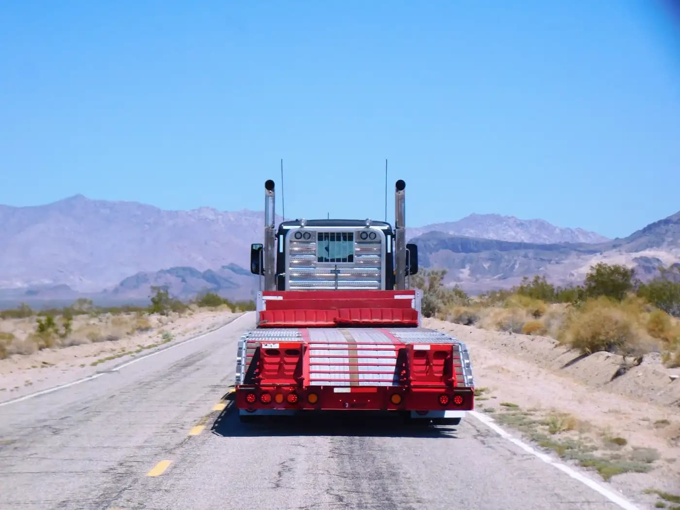 Empty car carrier on a desert road