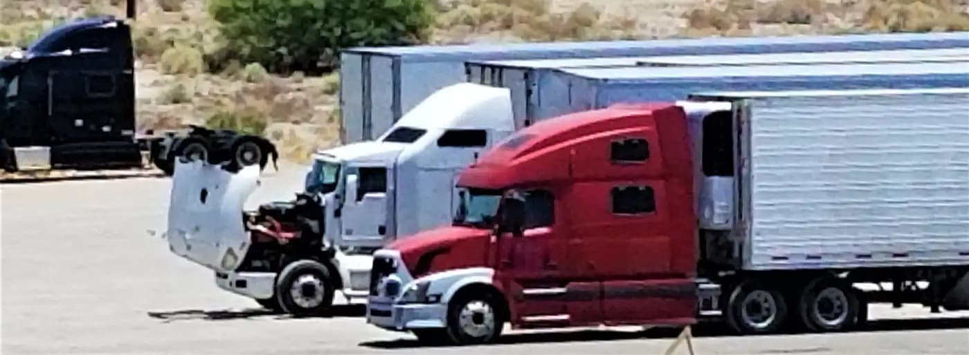 Semi-trucks parked in a lot