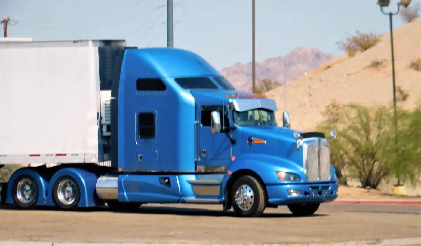 Blue tractor-trailer on a desert road
