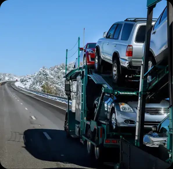 Open car carrier on a snow-lined road