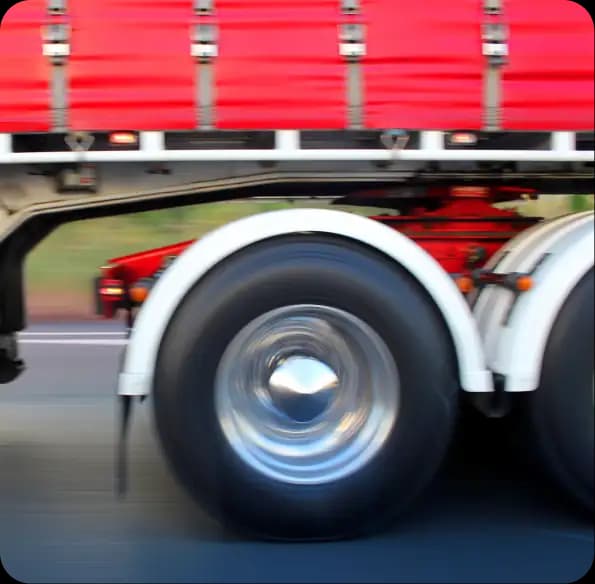 Wheels of a red trailer in motion