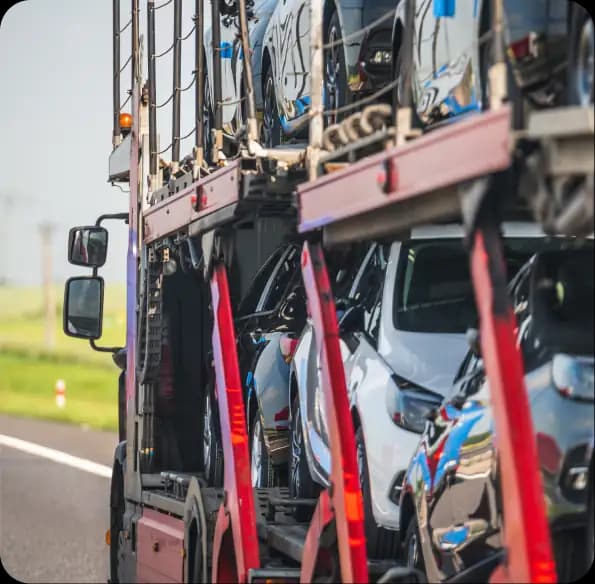 Open car carrier transporting multiple vehicles