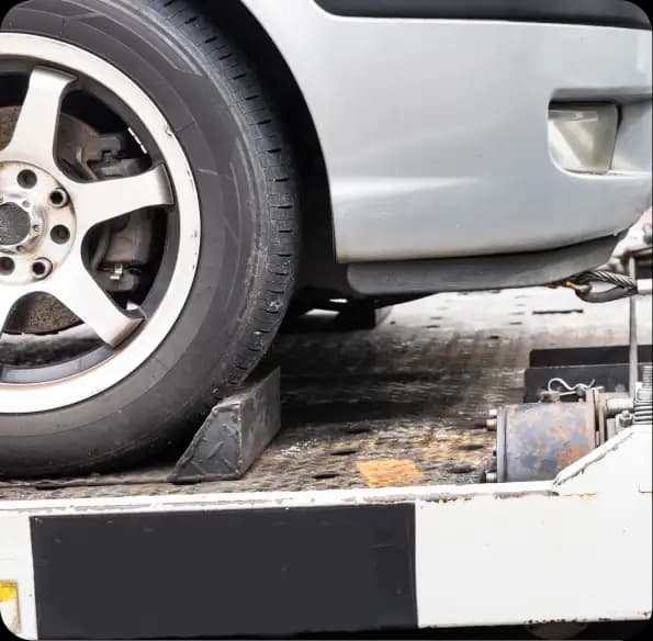 Car wheel secured on a transport bed