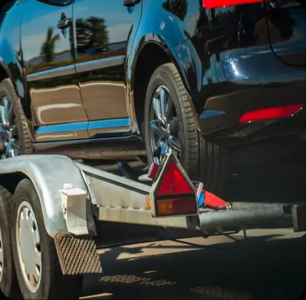 SUV secured on a vehicle trailer