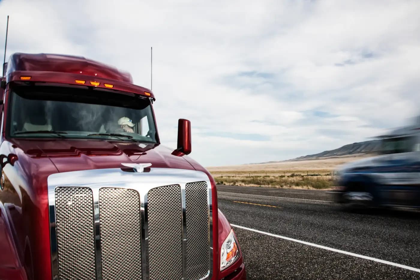 Front of a red semi-truck on a highway