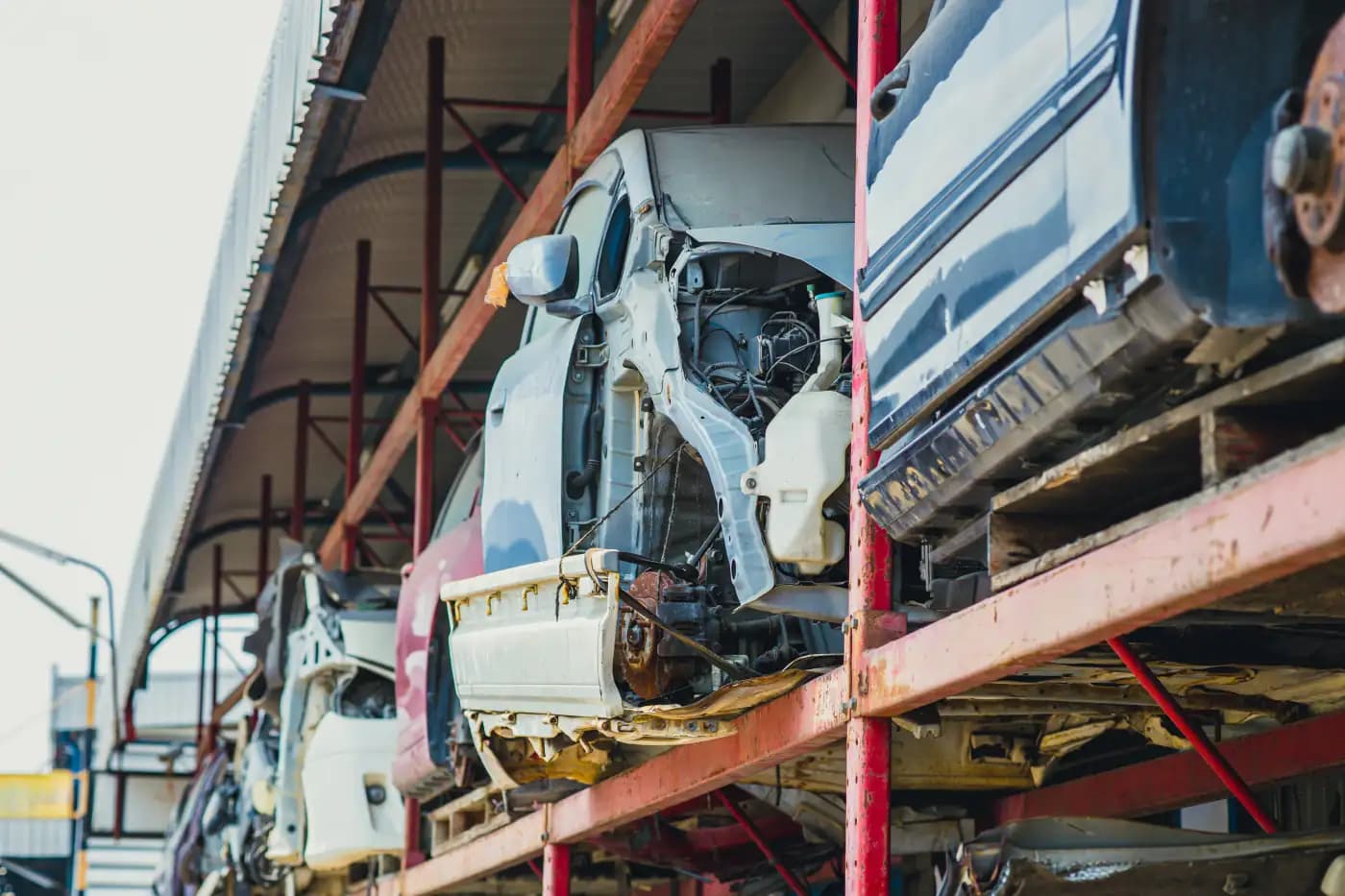 Damaged vehicle bodies stored on metal racks
