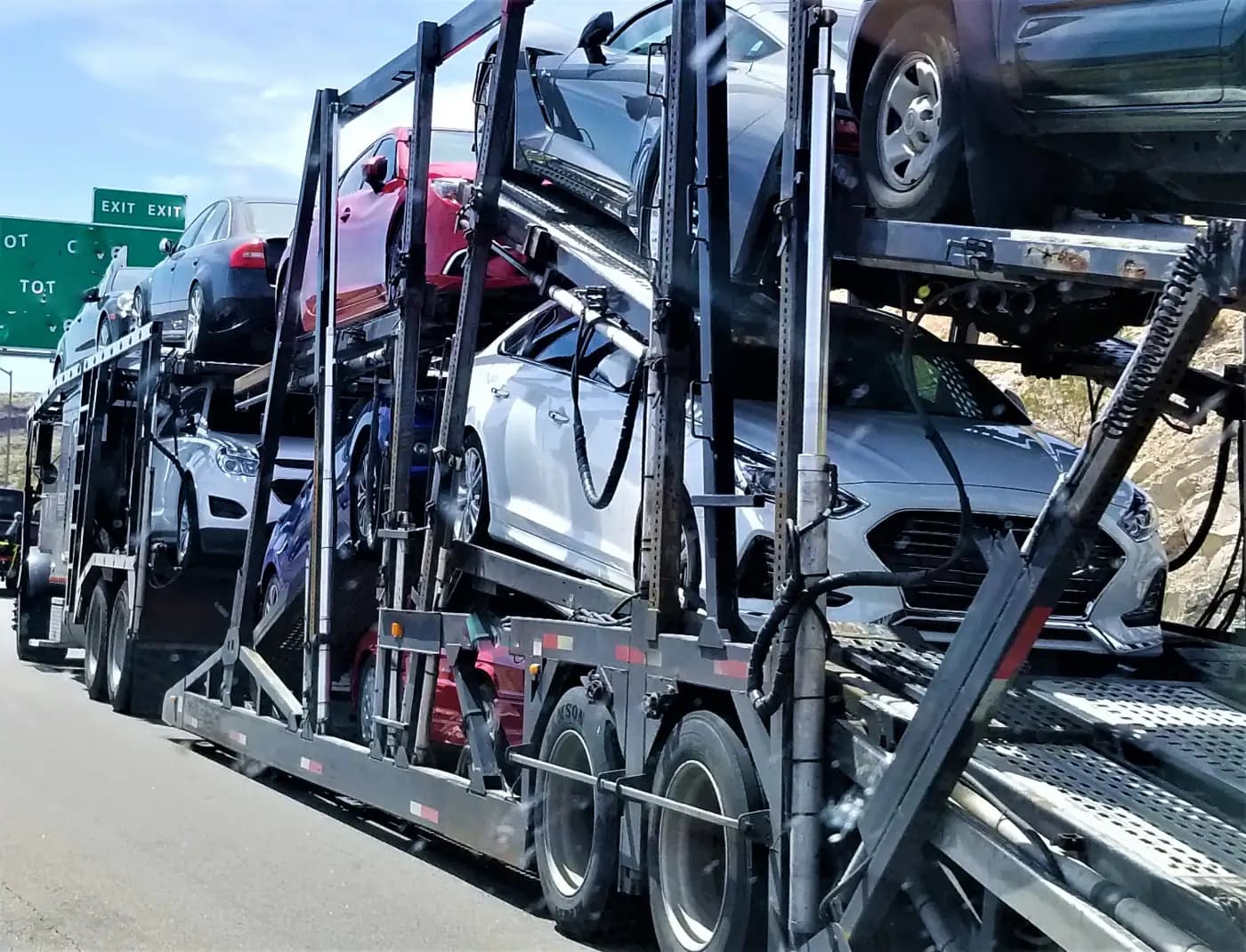 Open car carrier loaded with multiple vehicles